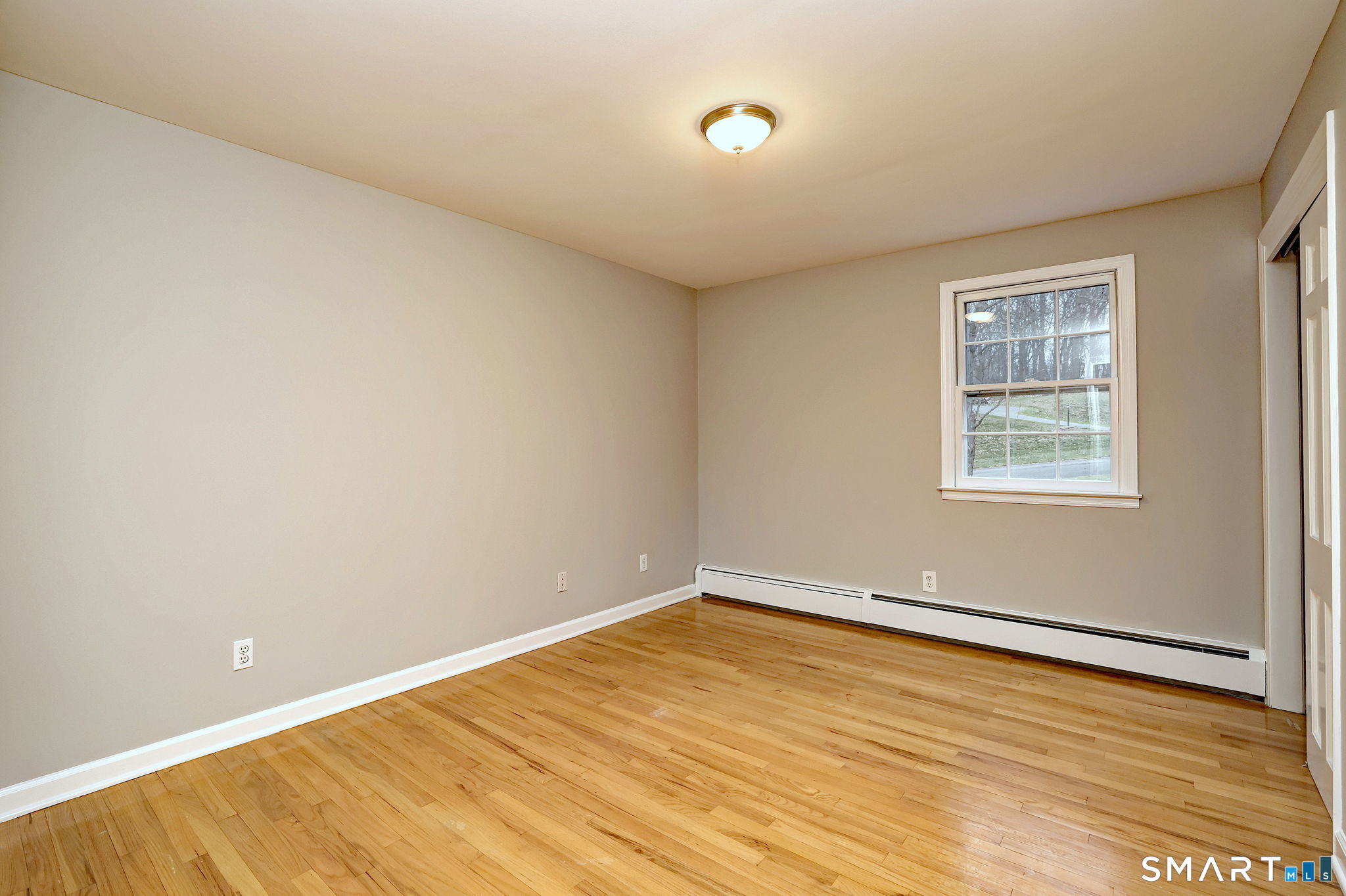 25 Shelter Rock Road Trumbull, CT 06611 - Photo 26 of 37 an empty room with wooden floor and windows
