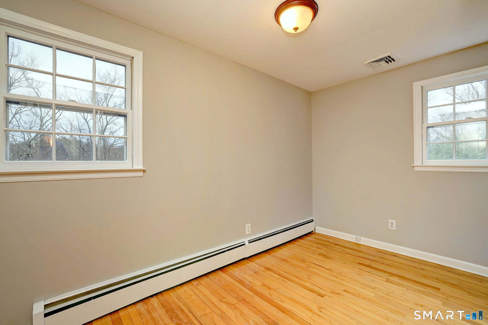25 Shelter Rock Road Trumbull, CT 06611 - Photo 27 of 37 a view of empty room with wooden floor and fan