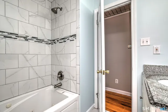 a bathroom with a tub a sink and a shower