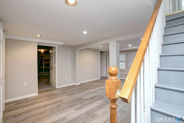 a view of living room with furniture and wooden floor