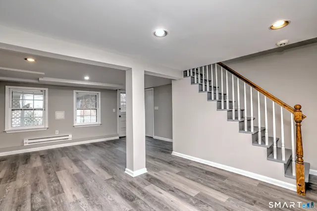 a view of an entryway with wooden floor
