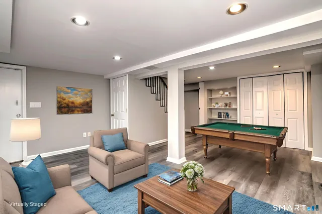 a living room with furniture and a wooden floor