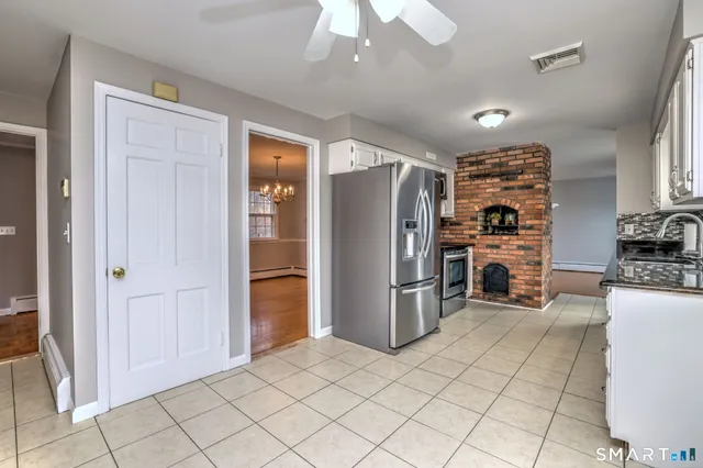 a kitchen with refrigerator and cabinets