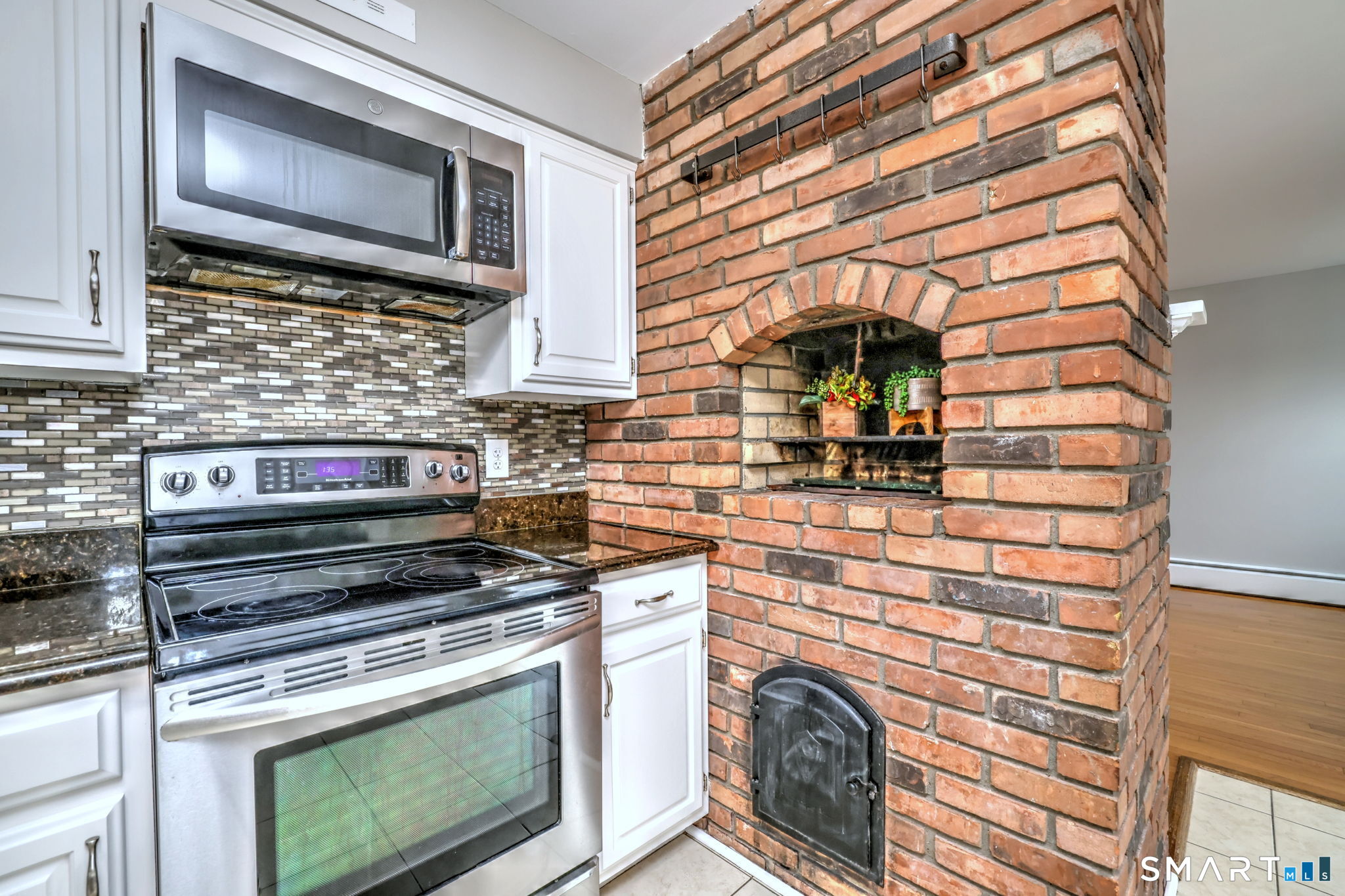 25 Shelter Rock Road Trumbull, CT 06611 - Photo 9 of 37 a kitchen with stove top oven and cabinets