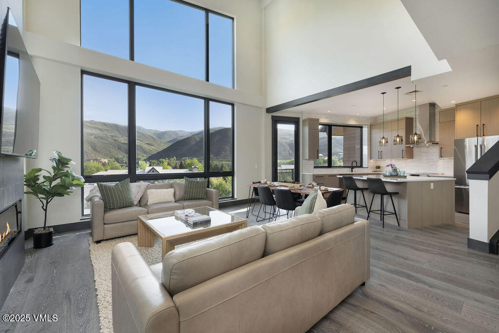 42 Riverfront Lane, Unit 507 Avon, CO 81620 - Photo 4 of 34 a living room with furniture wooden floor and a large window