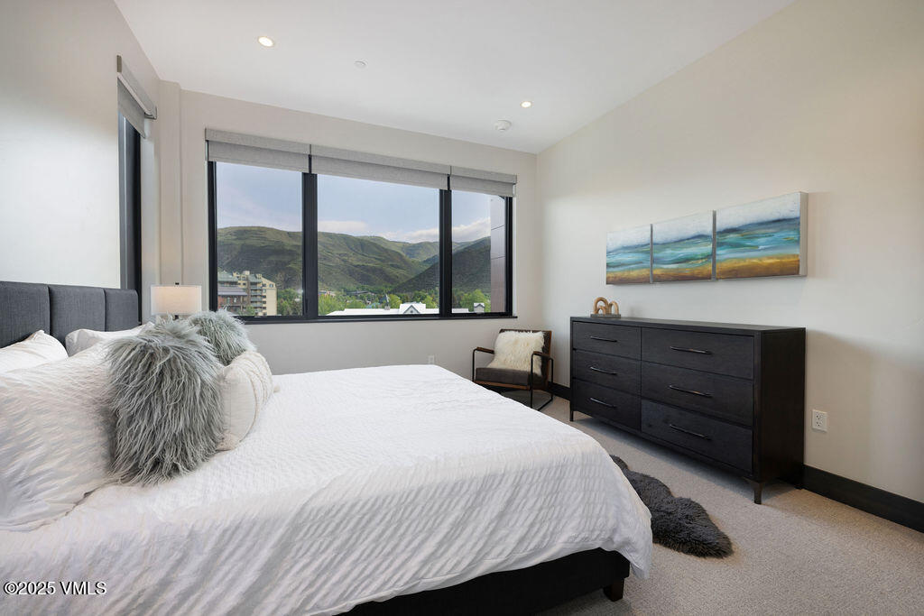 42 Riverfront Lane, Unit 507 Avon, CO 81620 - Photo 5 of 34 a bedroom with a bed and a dresser