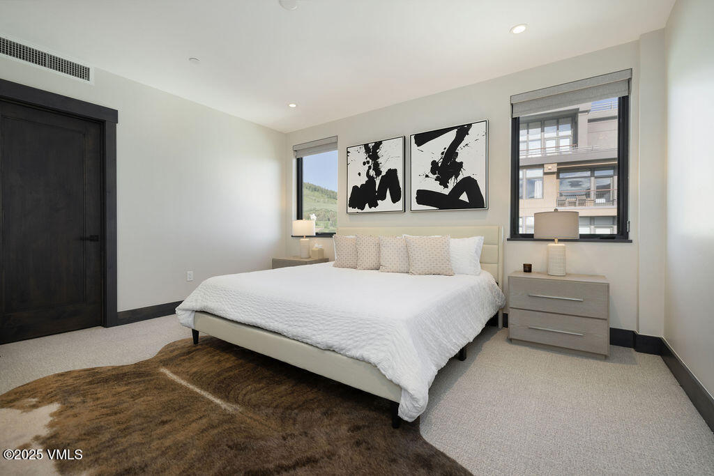 42 Riverfront Lane, Unit 507 Avon, CO 81620 - Photo 10 of 34 a bedroom with a bed and a window