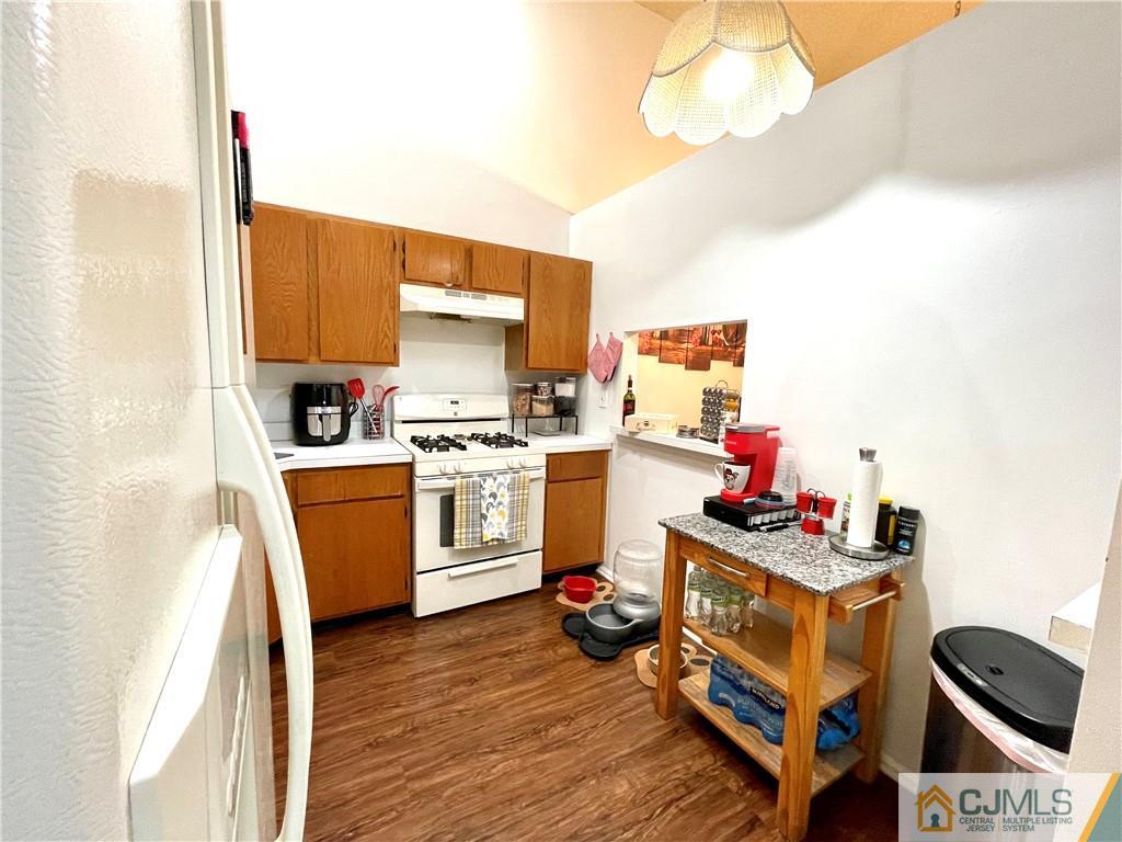 341 Wimbeldon Court North Brunswick, NJ 08902 - Photo 6 of 16 a kitchen with stainless steel appliances a stove top oven a sink dishwasher and a microwave oven with cabinets