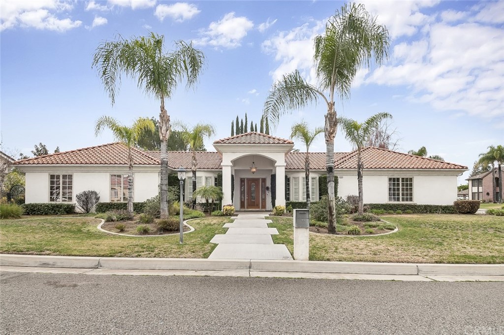 1544 Crestview Road Redlands, CA 92374 - Photo 1 of 1 a front view of a house with a garden and palm trees