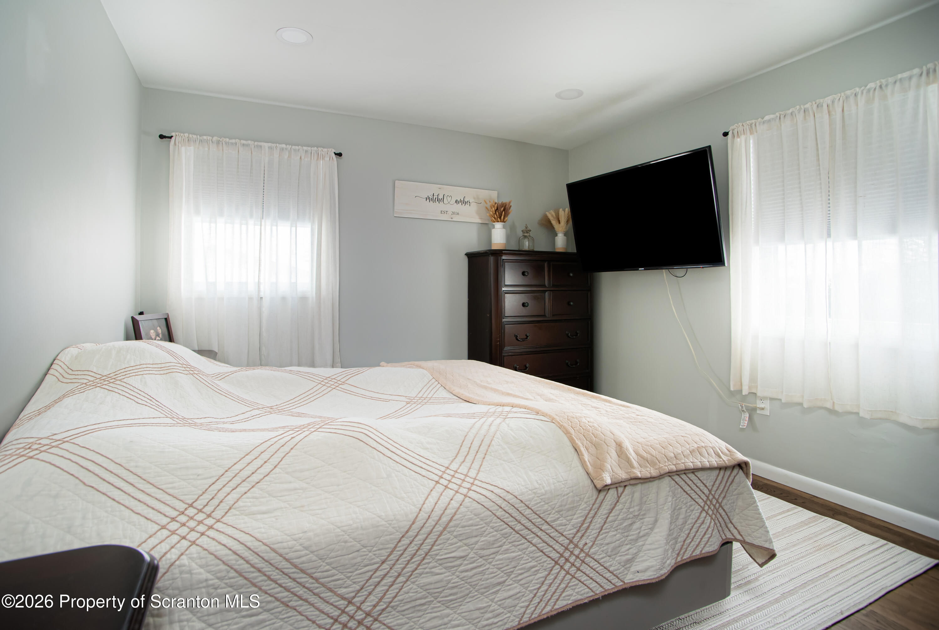 315 Tulip Circle Clarks Summit, PA 18411 - Photo 11 of 30 a bedroom with a bed and a flat screen tv