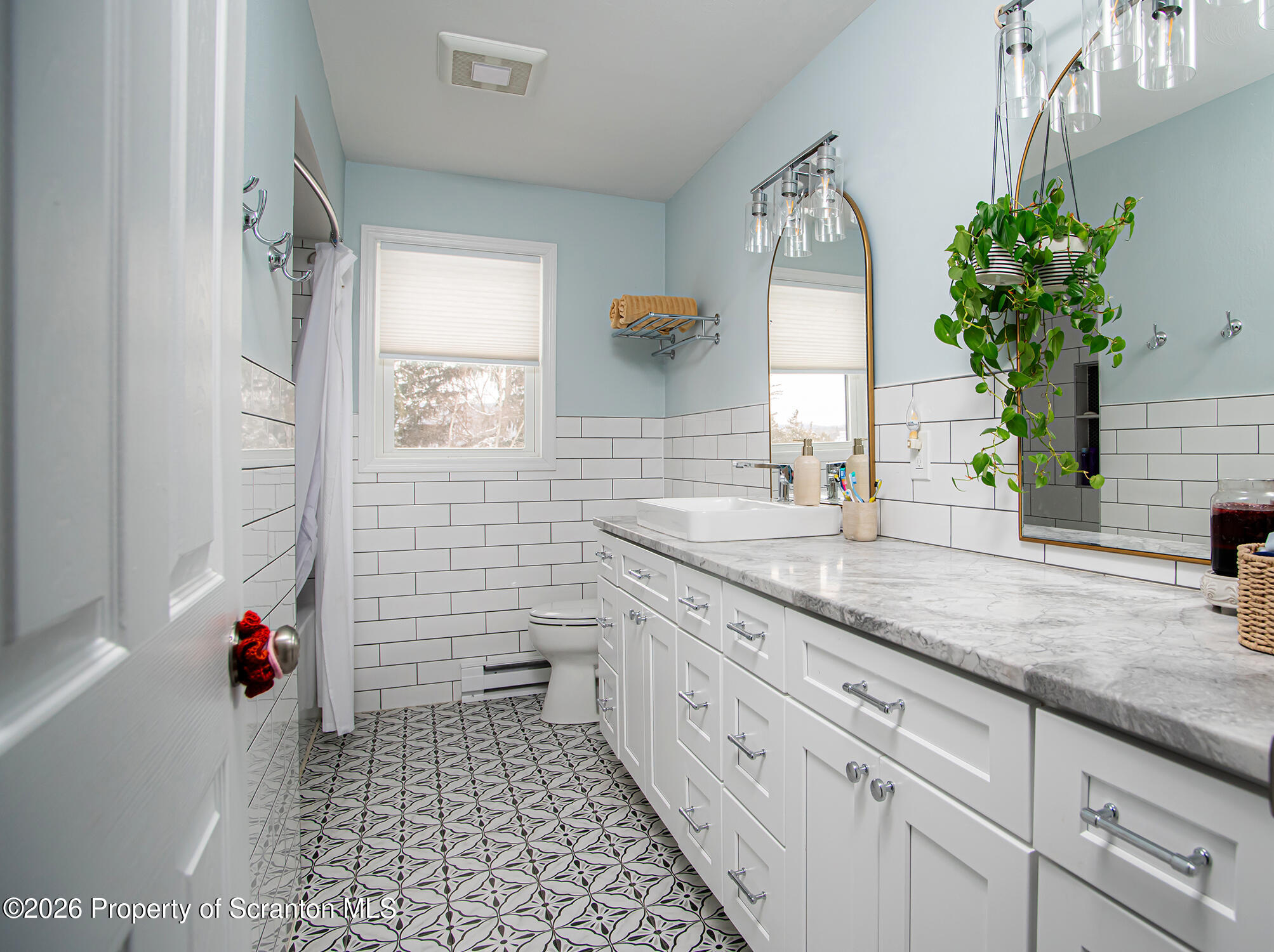 315 Tulip Circle Clarks Summit, PA 18411 - Photo 14 of 30 a bathroom with a granite countertop sink a potted plant and a shower