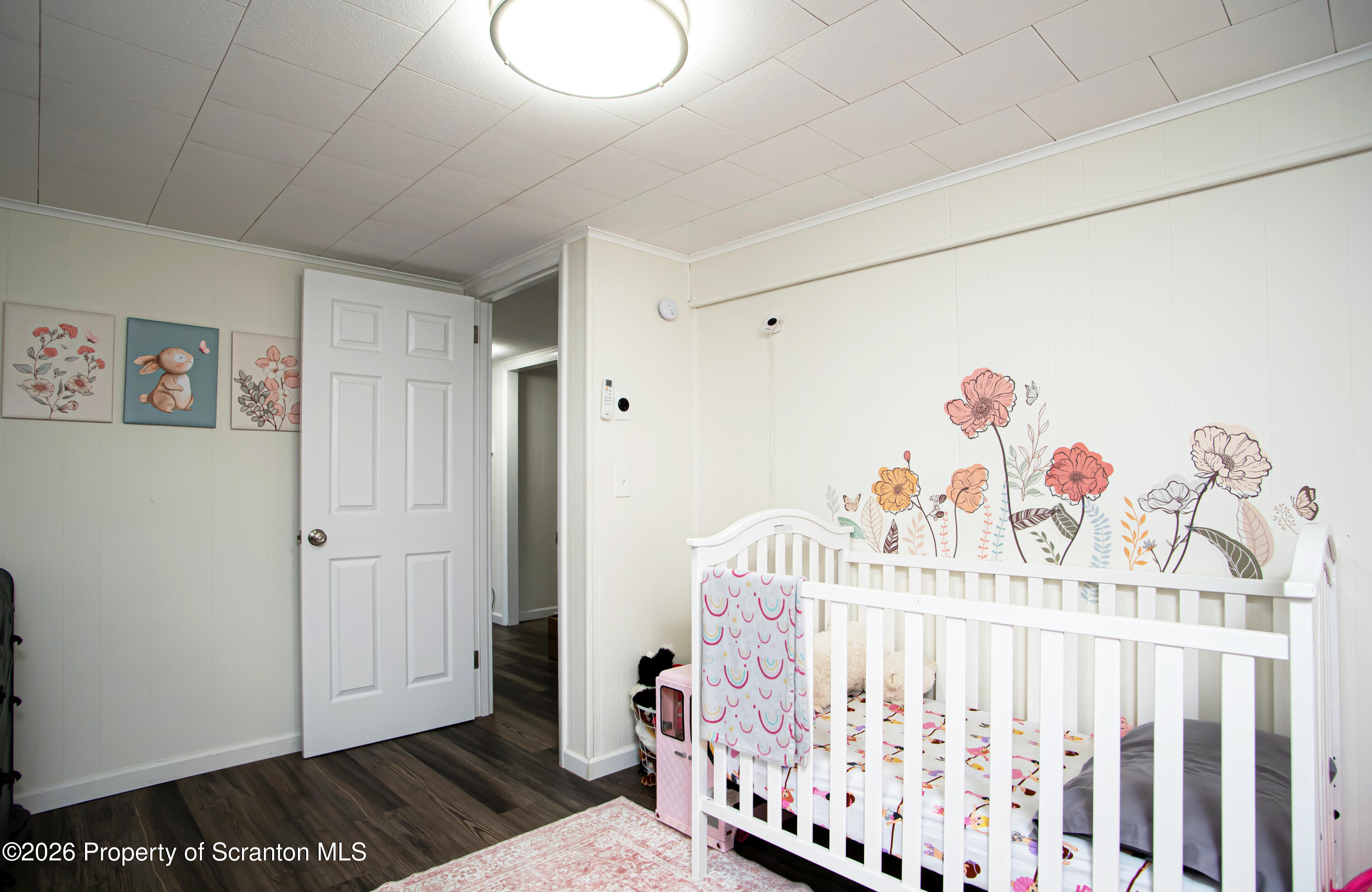 315 Tulip Circle Clarks Summit, PA 18411 - Photo 17 of 30 a bedroom with baby bed toys and paintings on the wall