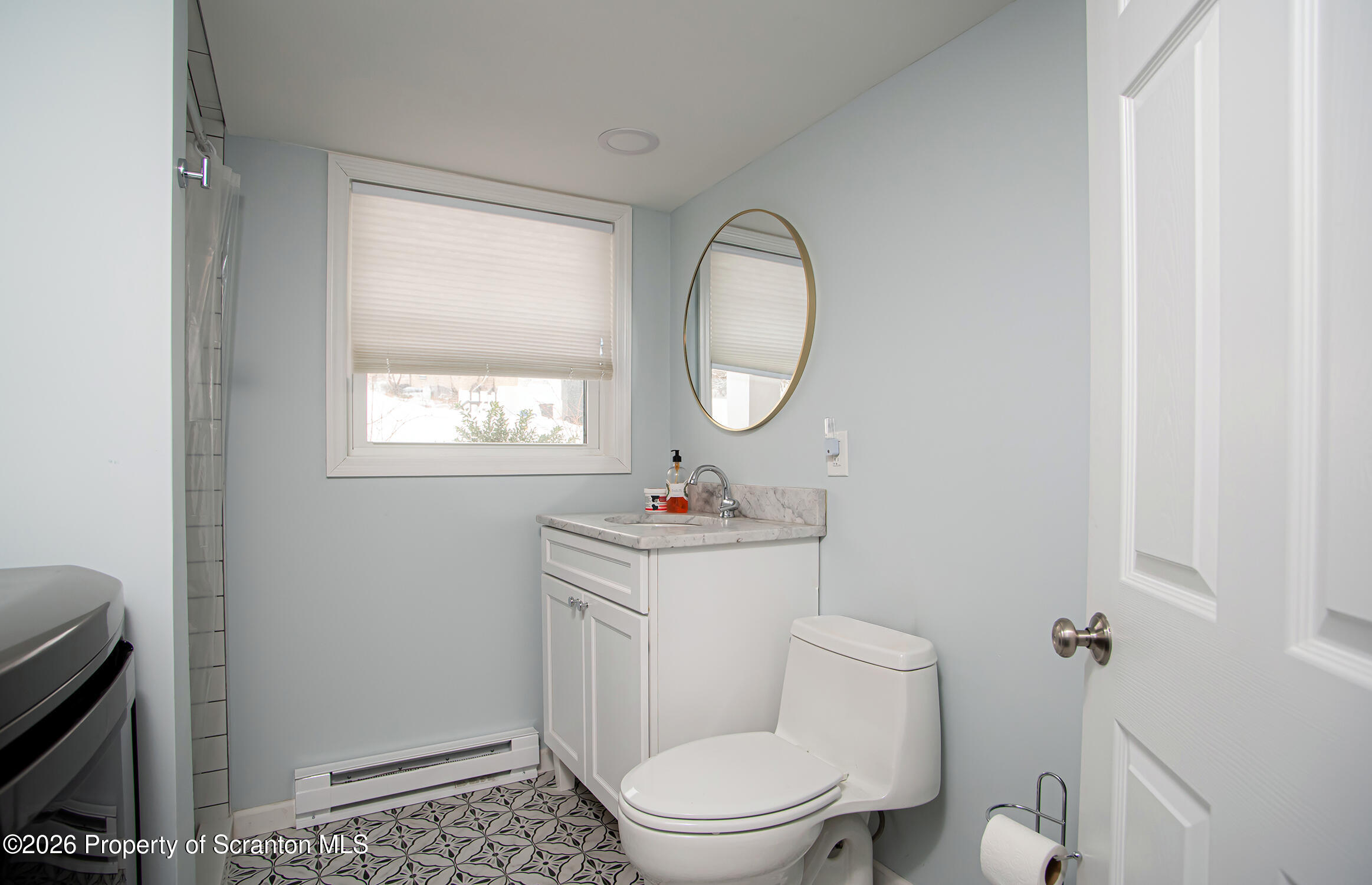 315 Tulip Circle Clarks Summit, PA 18411 - Photo 20 of 30 a bathroom with a toilet a sink a mirror and a window