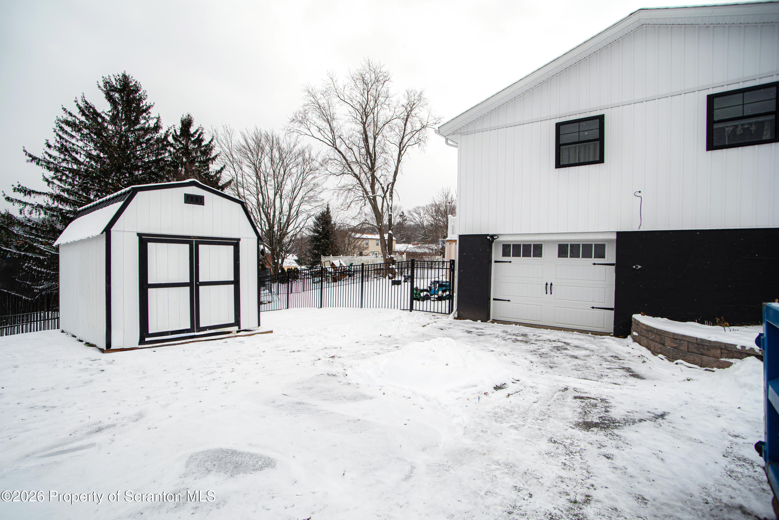 315 Tulip Circle Clarks Summit, PA 18411 - Photo 4 of 30 a view of white house with a yard covered in snow