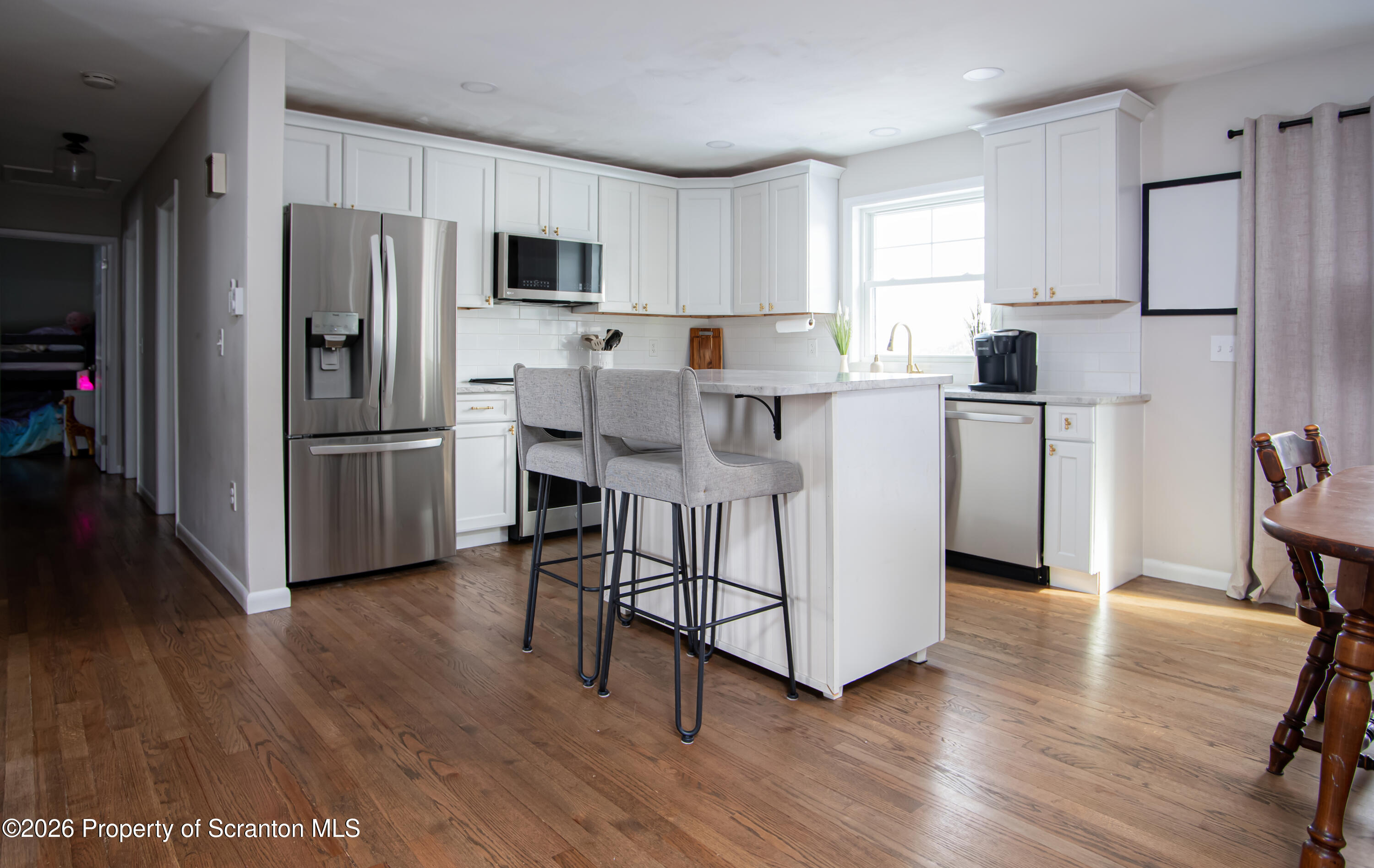 315 Tulip Circle Clarks Summit, PA 18411 - Photo 8 of 30 a kitchen with stainless steel appliances a refrigerator stove microwave and cabinets