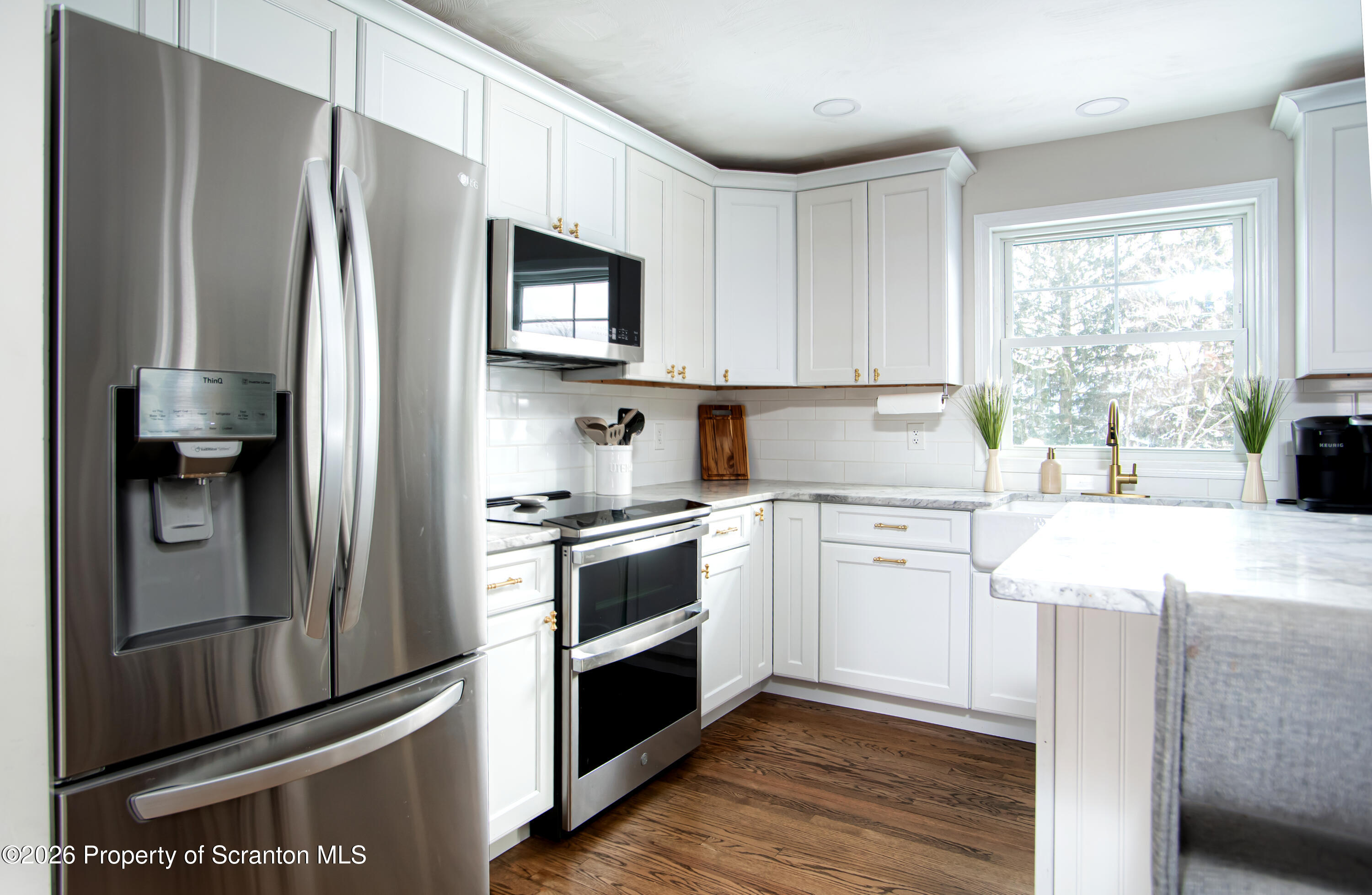 315 Tulip Circle Clarks Summit, PA 18411 - Photo 10 of 30 a kitchen with granite countertop a refrigerator stove and sink