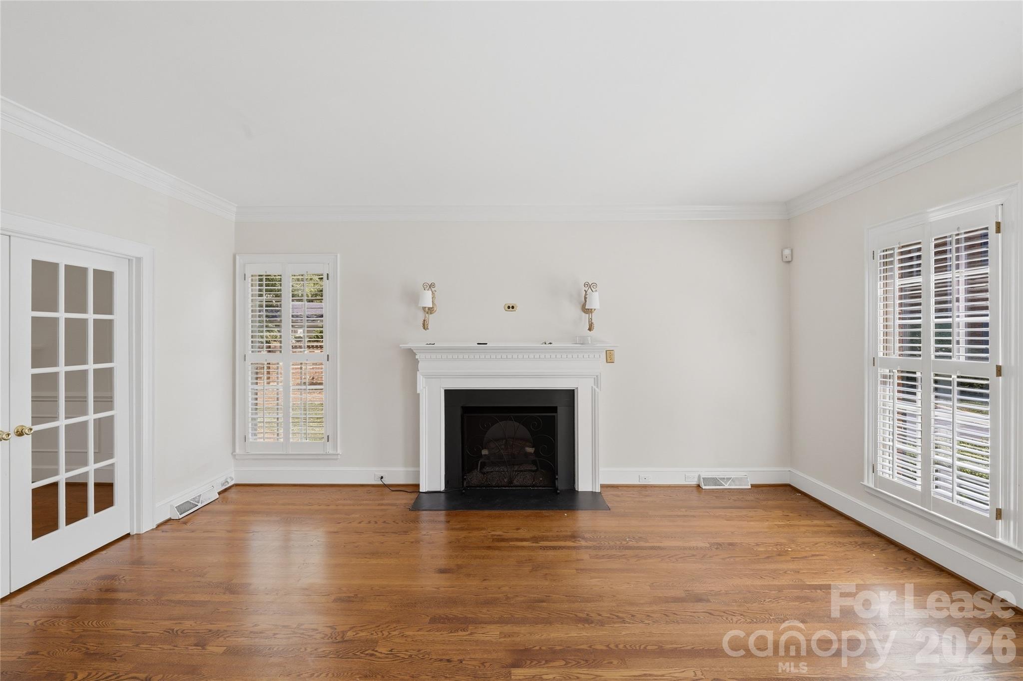 5906 Sharon Hills Road Charlotte, NC 28210 - Photo 2 of 30 an empty room with windows and fireplace