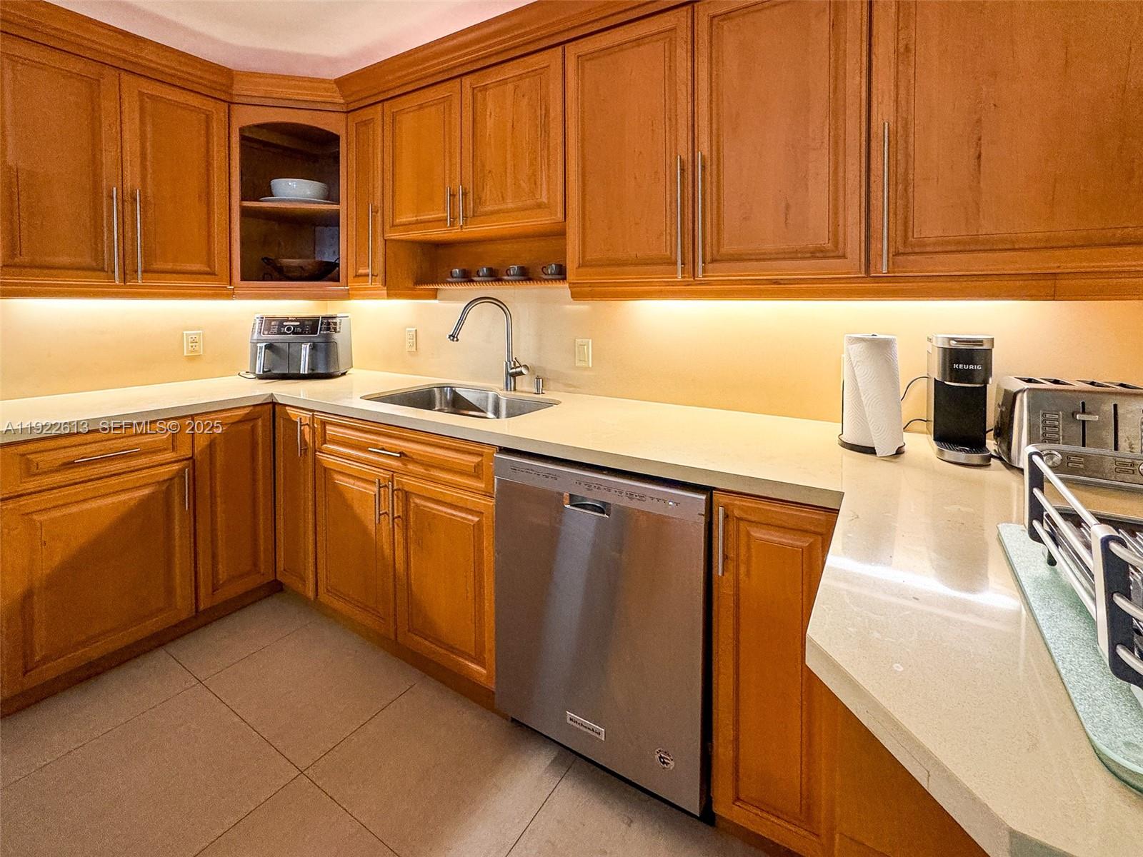 8877 Collins Avenue, Unit 809 Surfside, FL 33154 - Photo 11 of 46 a kitchen with stainless steel appliances granite countertop a sink stove and cabinets