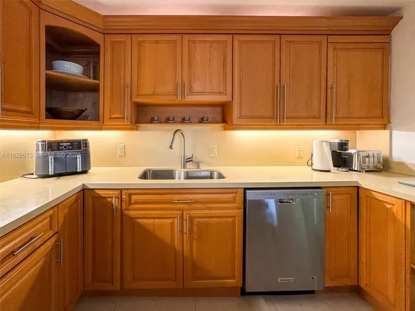 a kitchen with stainless steel appliances granite countertop a sink dishwasher stove and cabinets