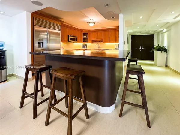 a kitchen with kitchen island table and chairs