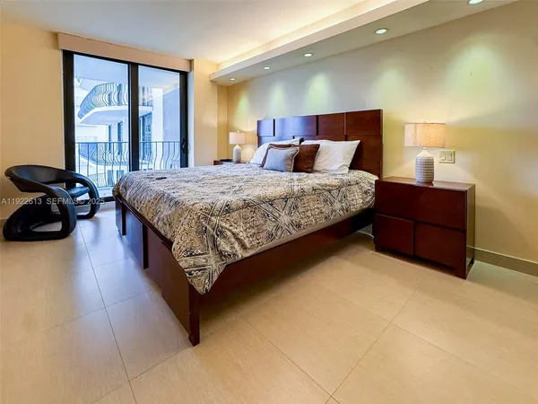 a bed sitting in a room next to a large window