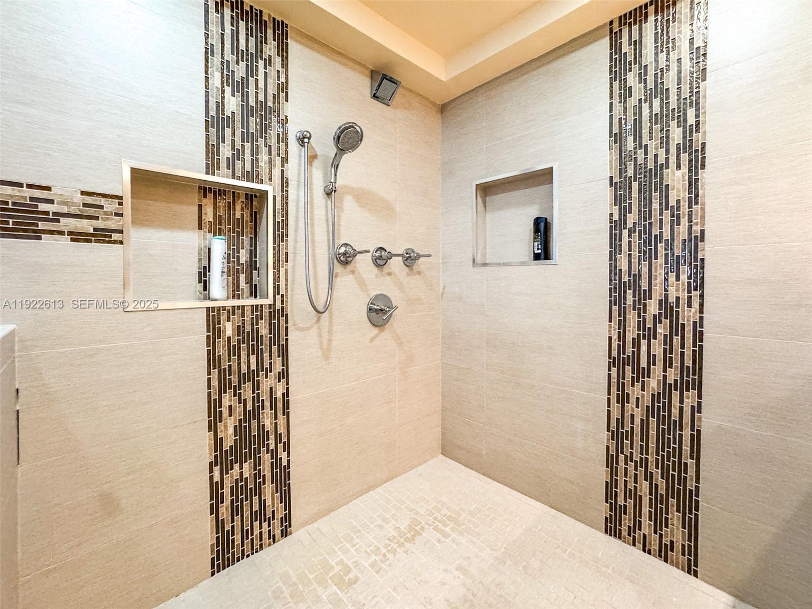 8877 Collins Avenue, Unit 809 Surfside, FL 33154 - Photo 27 of 46 a bathroom with a shower and a sink