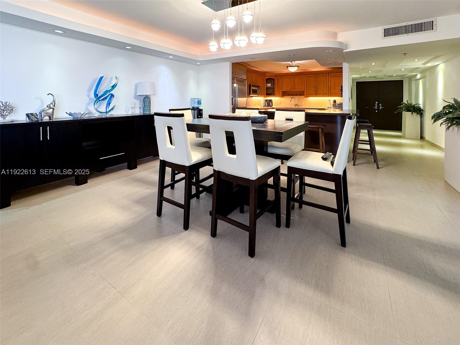 8877 Collins Avenue, Unit 809 Surfside, FL 33154 - Photo 34 of 46 a view of a dining room with furniture and chandelier