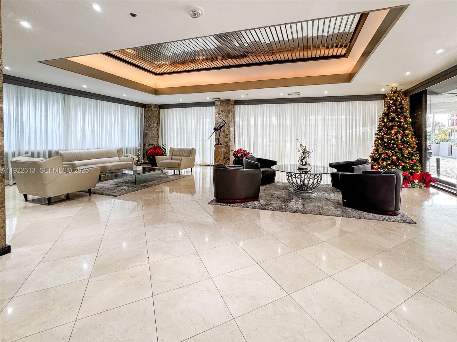 8877 Collins Avenue, Unit 809 Surfside, FL 33154 - Photo 37 of 46 a living room with furniture and a window