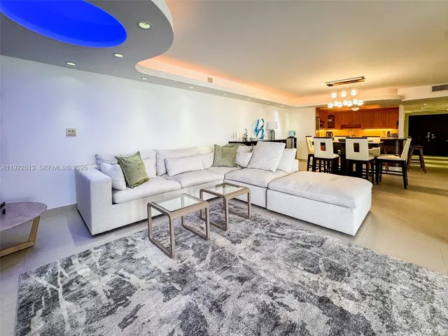 a kitchen with stainless steel appliances granite countertop a kitchen island a stove a sink dishwasher and cabinets with wooden floor