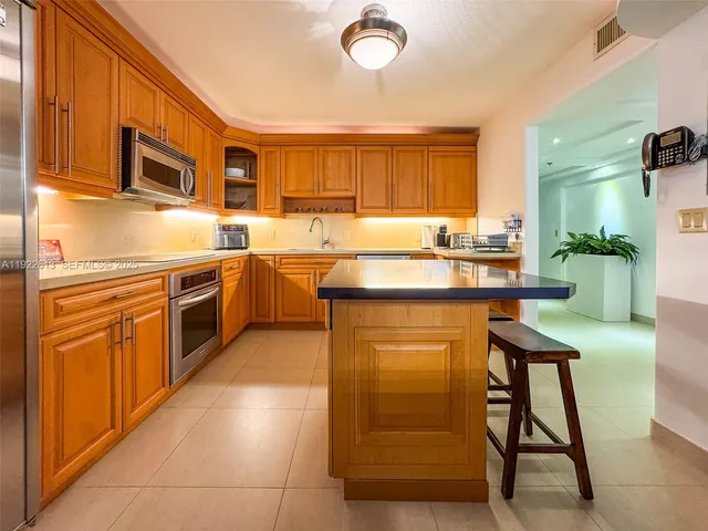 a kitchen with stainless steel appliances granite countertop a sink dishwasher stove and cabinets