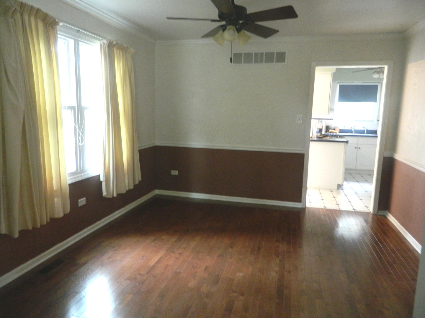 1101 South Raven Road Shorewood, IL 60404 - Photo 11 of 24 a view of empty room with wooden floor and fan