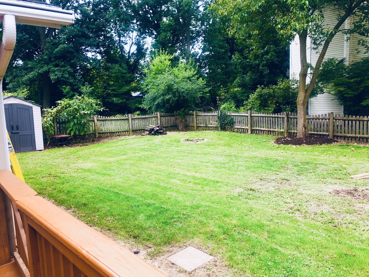 1101 South Raven Road Shorewood, IL 60404 - Photo 7 of 24 a view of a backyard with a small house and wooden fence