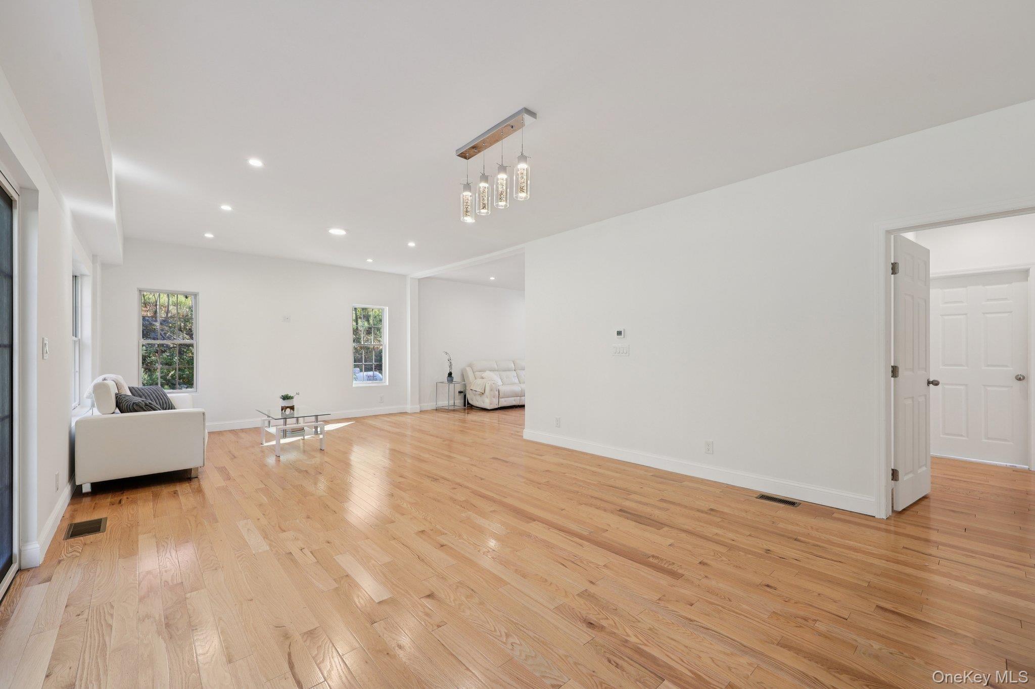 27 Oak Hill Road Monroe, NY 10950 - Photo 12 of 48 a view of an empty room with wooden floor and a window