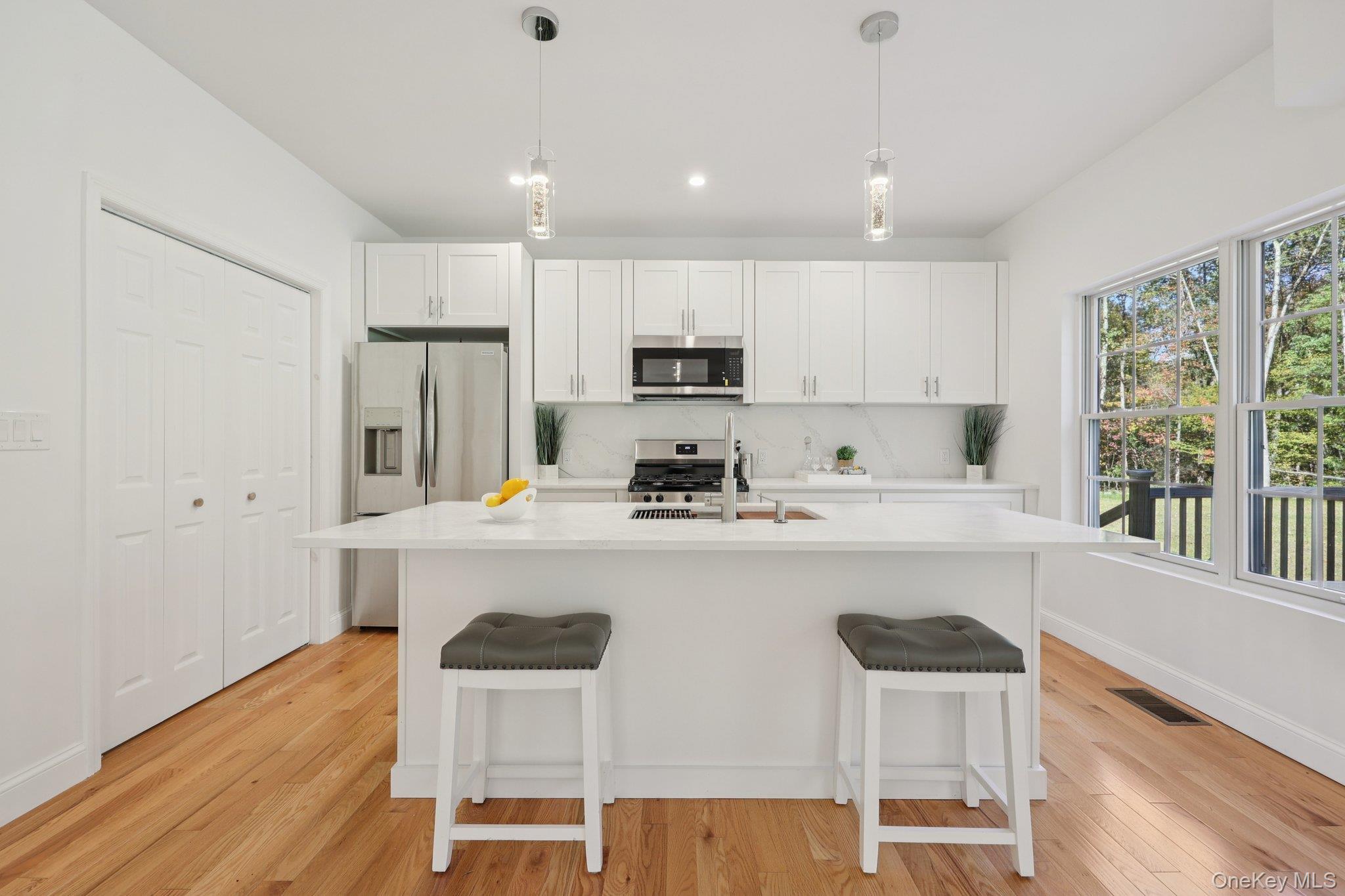 27 Oak Hill Road Monroe, NY 10950 - Photo 14 of 48 a kitchen with kitchen island white cabinets and stainless steel appliances