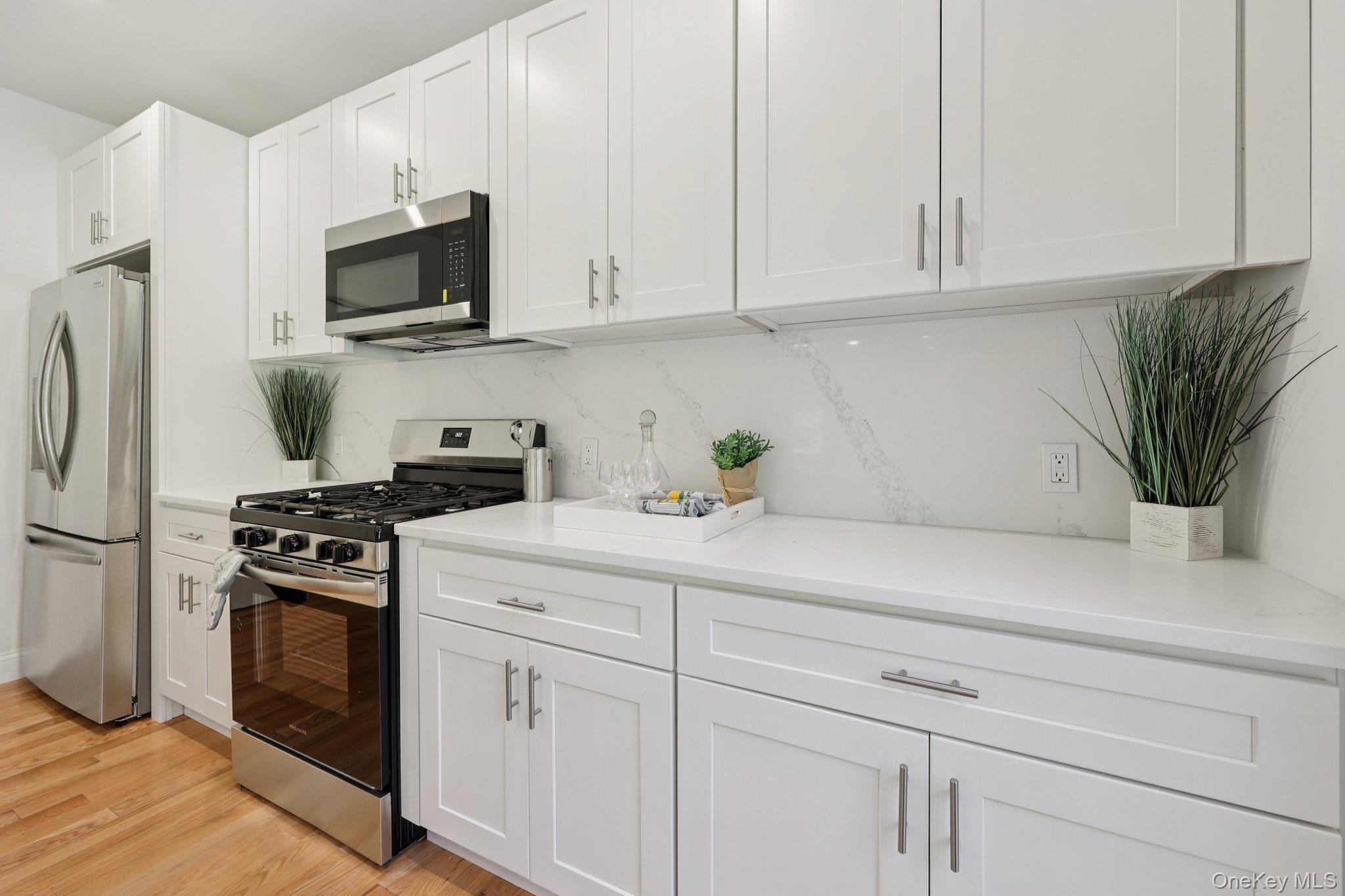 27 Oak Hill Road Monroe, NY 10950 - Photo 16 of 48 a kitchen with white cabinets and stainless steel appliances