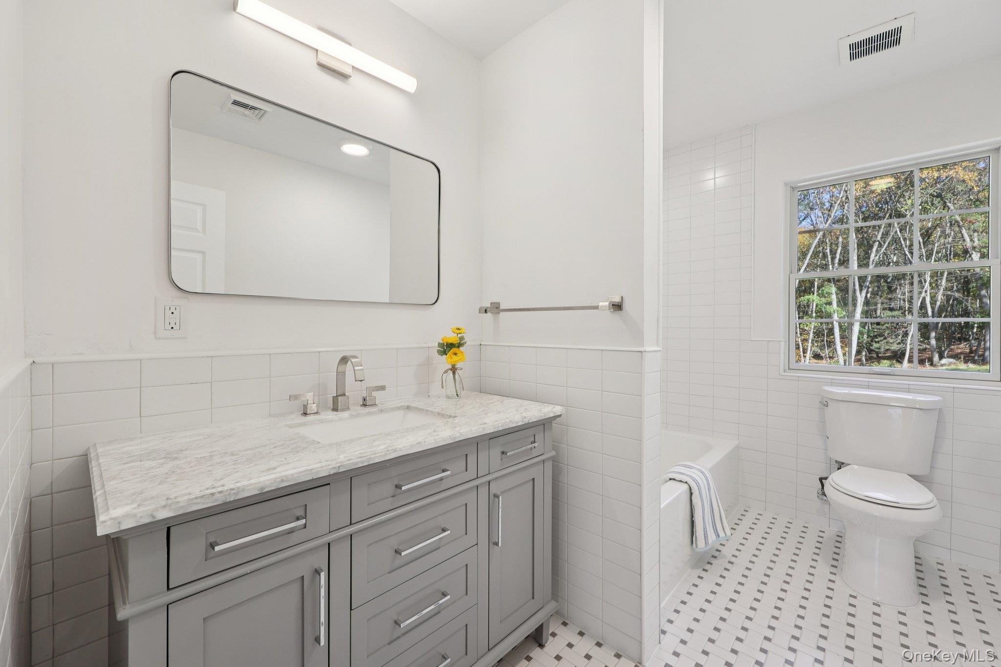 27 Oak Hill Road Monroe, NY 10950 - Photo 22 of 48 a bathroom with a granite countertop sink a toilet and a mirror