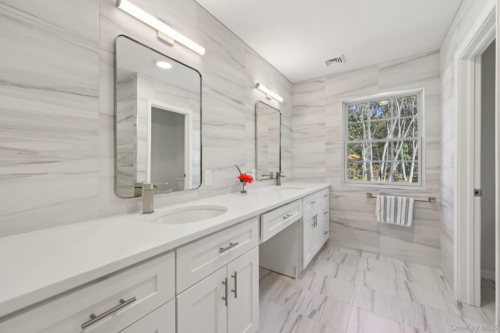 27 Oak Hill Road Monroe, NY 10950 - Photo 27 of 48 a spacious bathroom with a double vanity sink a mirror and a bathtub
