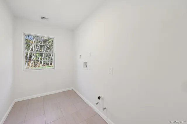 a bedroom with a bed and a potted plant