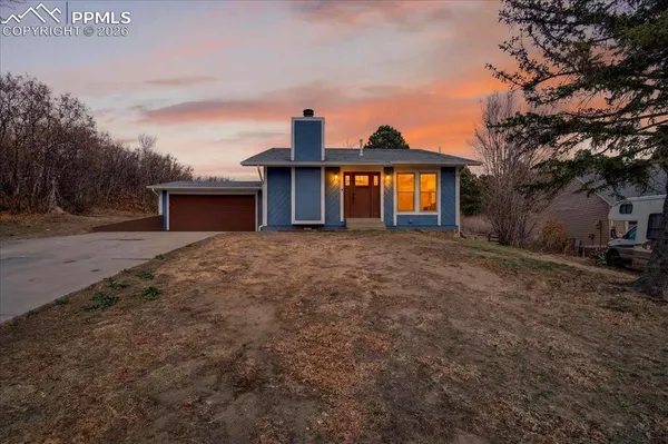 a view of a house with a yard and roof