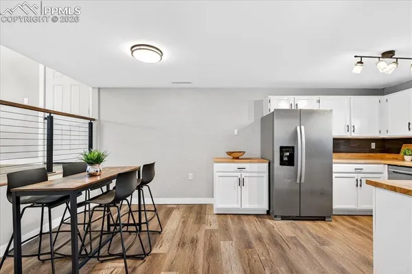 a kitchen with granite countertop white cabinets and stainless steel appliances