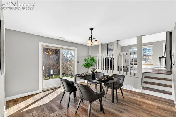a view of a dining room with furniture window and wooden floor