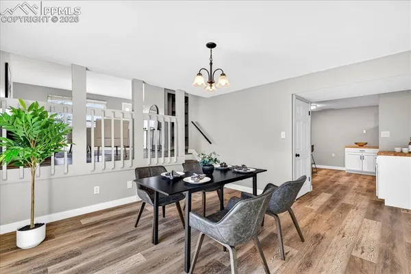 a dining room with furniture and wooden floor