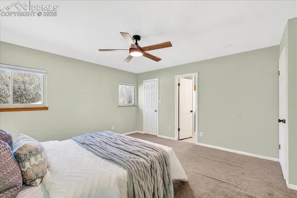 a bedroom with a large bed and a chandelier