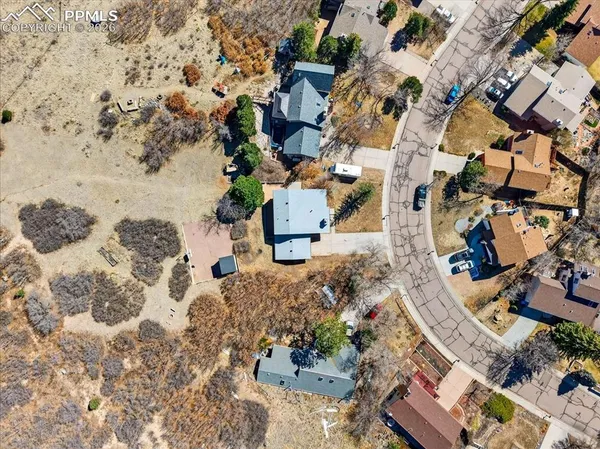 an aerial view of residential houses with outdoor space