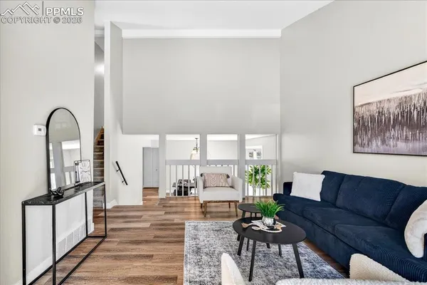 a living room with furniture fireplace and a potted plant