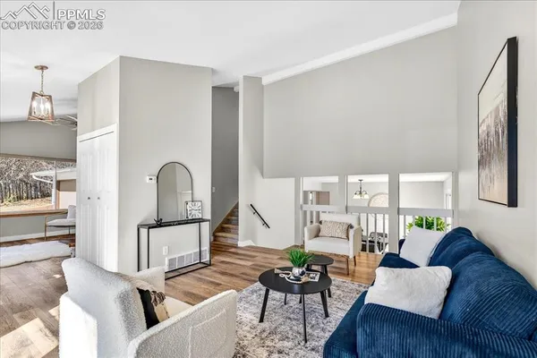 a living room with furniture and wooden floor
