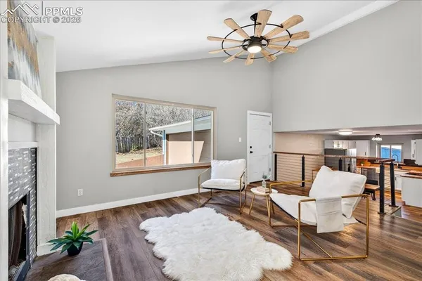 a living room with furniture or chandelier and a wooden floor