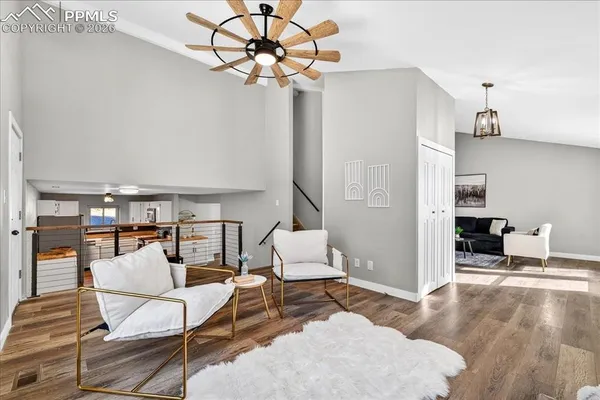 a living room with furniture and a wooden floor