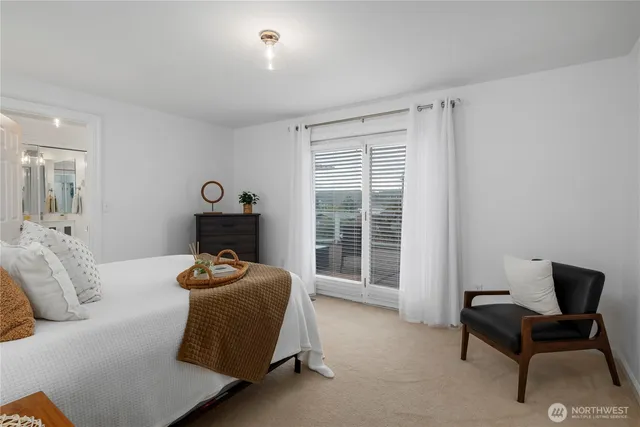 a work room with furniture a rug and white walls