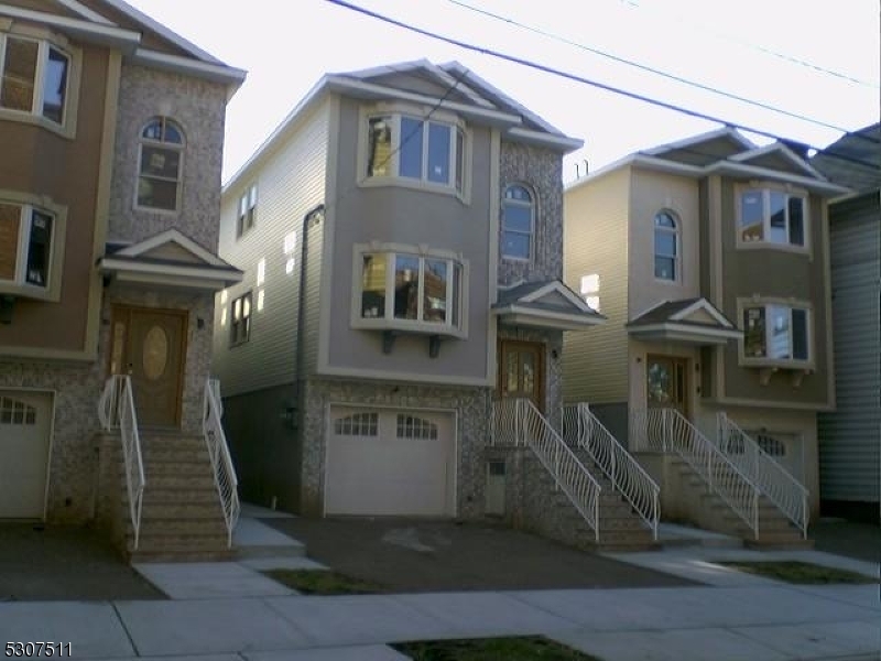 110 South 3rd Street Harrison, NJ 07029 - Photo 1 of 7 a front view of a house with a yard